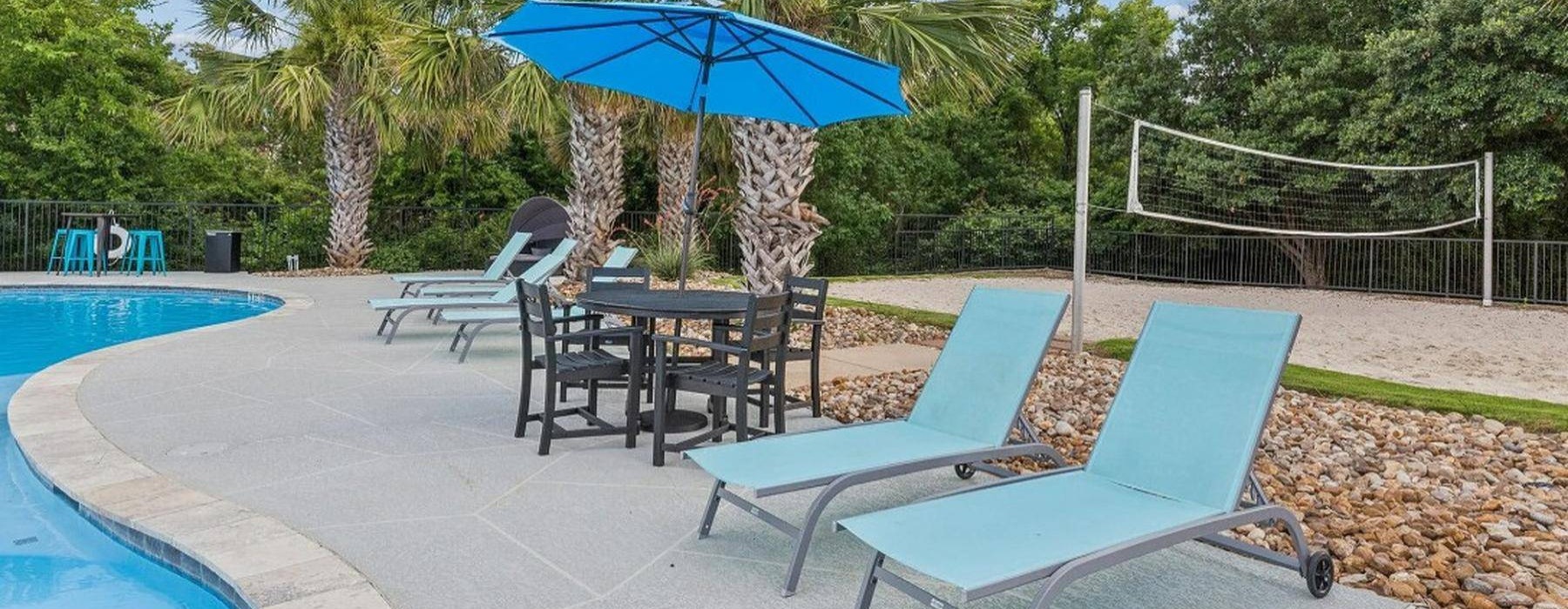 a pool with chairs and umbrella