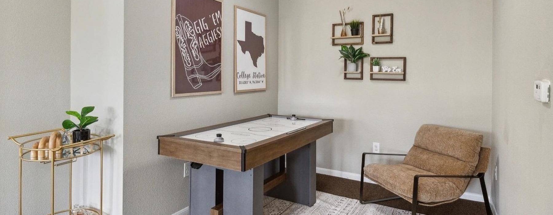 a room with an air hockey table and a chair